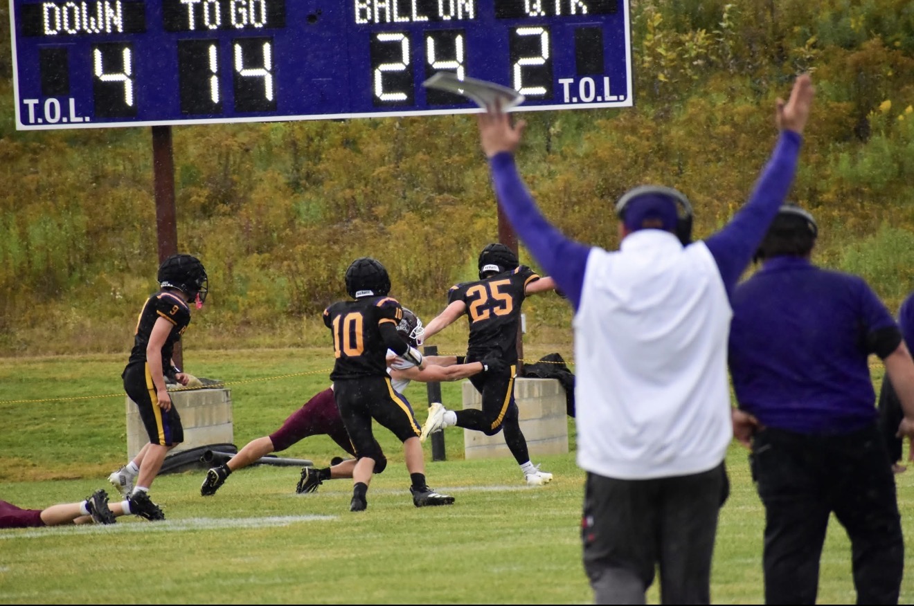 Mascoma players in action against Fall Mountain as coaches celebrate during Homecoming