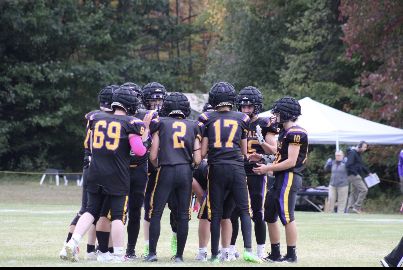 Mascoma Royals football players huddling together on the field