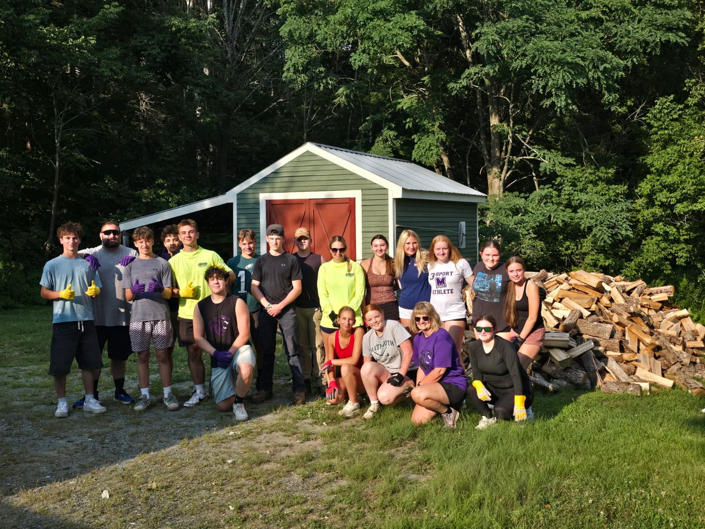 Mascoma Football and Field Hockey team members after stacking firewood in the community